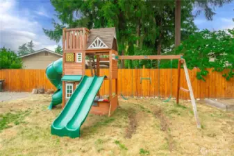 This fun-filled wooden play set stays with the home and is ready to spark hours of outdoor adventure. Featuring dual slides, a spiral tube slide, swings, and a clubhouse with built-in games, it’s the perfect backyard playground for kids to explore, climb, and imagine—all within the safety of your fully fenced yard.