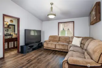 Luxury Vinyl Plank floors, vaulted ceilings and window placement for perfect theater set up - adds a whole additional space for gatherings or entertaining!
