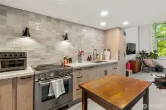 Updated kitchen (2023) with custom cabinetry + tile backsplash.