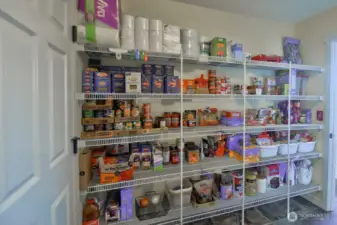 Pantry/mud room area with more than ample space for all those pantry needs. Leads to garage