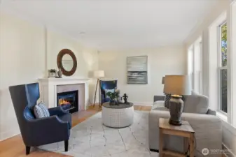 The living room features a double-sided fireplace and is filled with plenty of natural light.