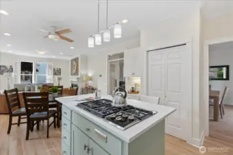 Open-concept kitchen that connects to the dining room, family area, and backyard. Notice the abundance of light flowing into these spaces.