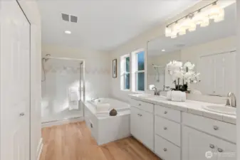 Primary bathroom features a double vanity, soaking tub, separate shower, and a private commode to the right.