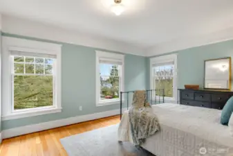The primary bedroom is on the NW corner  with multiple windows for natural light. This  room faces the front of the house.