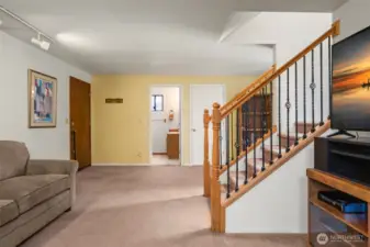 Cozy downstairs living space with stove.