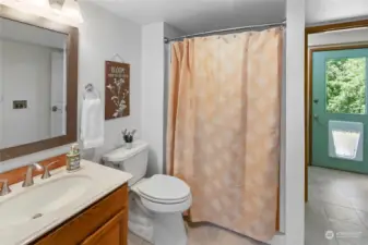 Perfectly sized 3/4 bath connects to the laundry area, the outside, and upstairs!