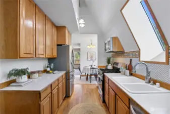 Another view of the kitchen, plenty of cabinetry and counter space, and a walk-in pantry is just around the corner for all your supplies!