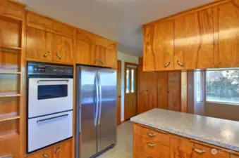 Stainless Steel Whirlpool refrigerator with a double oven.