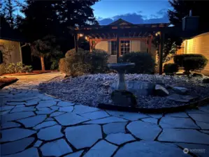 Great shot of the front of the home with lit up pergola at night!