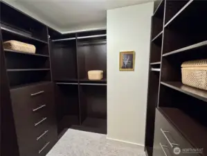 Enjoy custom California Closet systems the large walk-in closet in the primary suite.