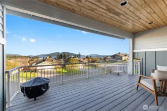 Deck off living room that is covered on three sides.