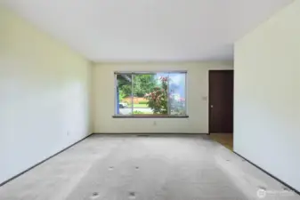 Looking at the Livngroom window & space- hall is to the right- with the shared bath at the end.