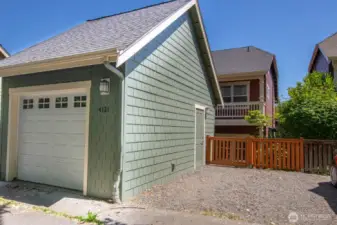 Detached garage with an extra parking pad offers flexible options for storage and vehicles.