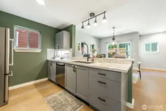 Modern kitchen with updated appliances and a seamless flow into the dining area and backyard.