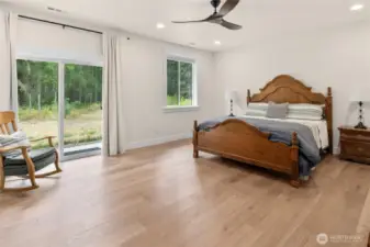 Expansive primary bedroom with private patio.