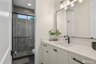 Three quarter bathroom in between the guestrooms.