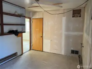 Garage Room with power and water. Heated. There is another room behind the wooden door as well.