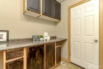 These cabinets and folding counter are across from the washer and dryer.
