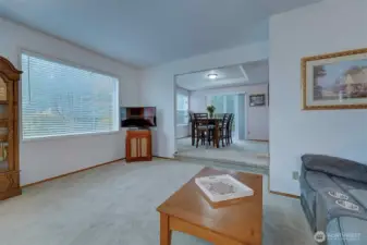 Living room flows to dining room where you can also exit to the deck for some sunshine or outdoor dining