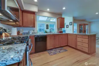 Granite countertops and wood floors give the kitchen that updated look. Plenty of storage space. Gas stove/oven, built-in microwave.