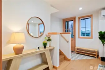 Front door entrance has tile flooring to prevent damage to the wood floors.