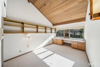 Vaulted cedar ceilings, built in desk area & large windows bring in natural light, making this bedroom feel bright and airy.