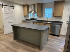 Kitchen from living room looking at flex room/utility room door.