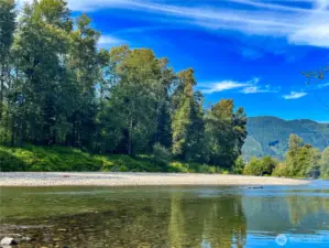 a view from the riverbed on the far end of the property