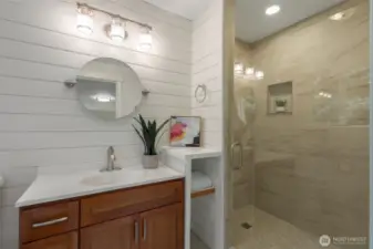 Primary ensuite bathroom with penny tiles, custom cabinets and beautiful tile surround.