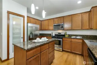 Kitchen with slab granite, pantry, and gas cooktop