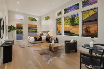 Main level guest suite with kitchenette, sitting area, two entrances, walk in closet & yard access