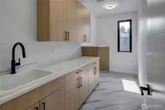 Laundry room with sink located upstairs for convenience (photo of similar home in separate community)