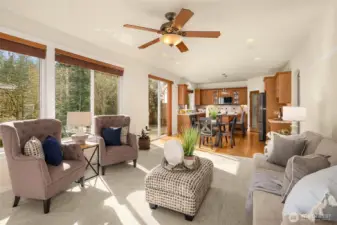 The heart of the home — bright, open, and connected to the kitchen and casual dining area, all with greenbelt views.