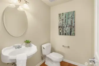 The main floor powder room features a classic pedestal sink.
