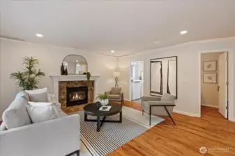 The family room is located just off the kitchen and features a gas fireplace, hardwood floors and new LED lighting