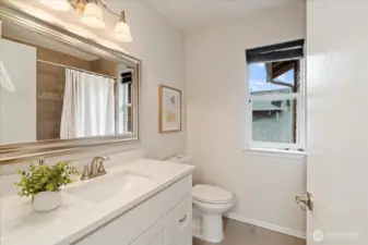Updated guest bathroom with new vanity, quartz counters and mirror