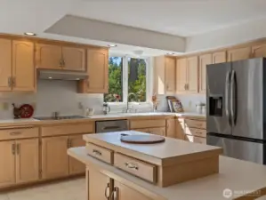 Large open Kitchen with center island, solid cabinets & lots of storage, new stainless steel appliances, subway tiles & fresh paint - overlooks the large Deck & Backyard.