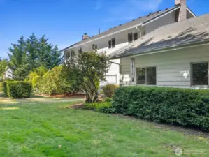 Beautiful sprawling yards create outstanding outdoor spaces, with    mature trees, many blooming flowers, & large wooded area.