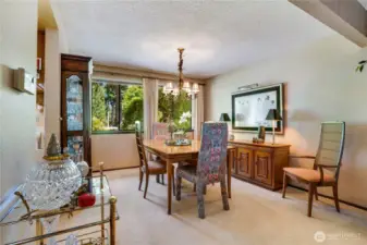 A bright dining room with big windows showing off the golf course.