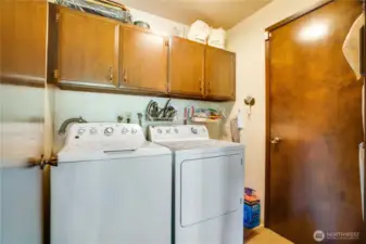 Main floor laundry with access to oversized garage with workshop space.
