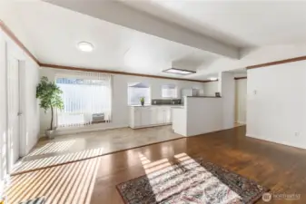 A look from the Living Room into the Dining Room with the Kitchen to the right.