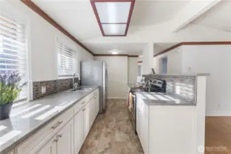 Kitchen remodeled in 2021. New quartz countertops, flooring, cabinets.