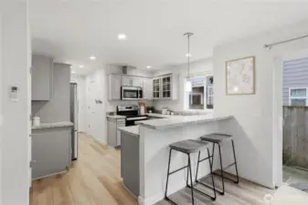 Room to sit at the kitchen bar and visit while preparing meals.