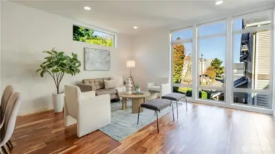 Floor-to-ceiling windows fill the room with natural light.