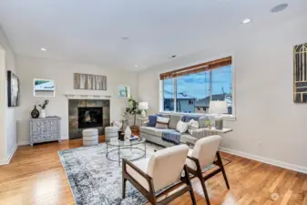 Family room with gas fireplace and large windows overlooking the yard