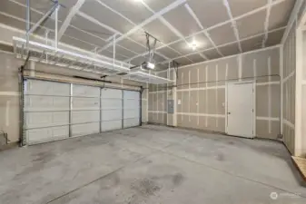 Garage with storage shelves and access to the side yard