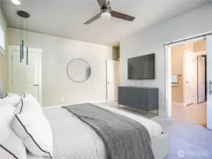 Primary bedroom with custom lighting and ceiling fan. Second closet off bedroom. Another walk in closet off the bath.