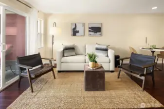 Light and bright living room with sliders to deck. With doors open it feels like you are bringing the outdoors in. Open floor plan for living room, kitchen and dining.