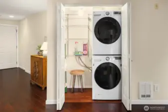 Convenient hall laundry with plenty of storage.