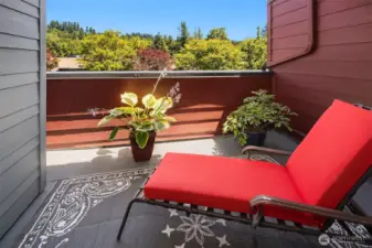 The private deck is perfect for lounging, or possibly a nap with with a pretty view of the trees.
